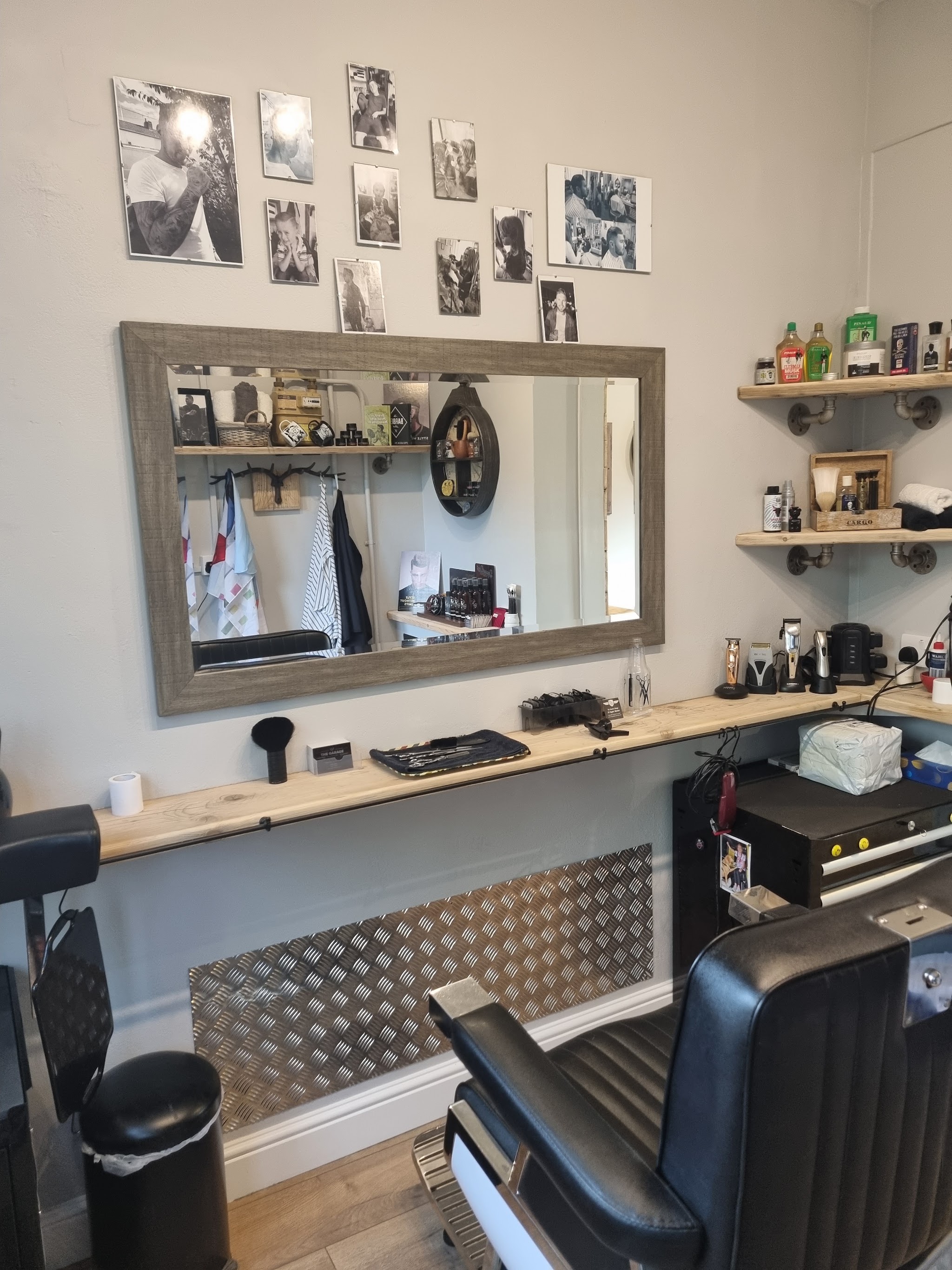 The second station with a black chair and a wall of framed photos