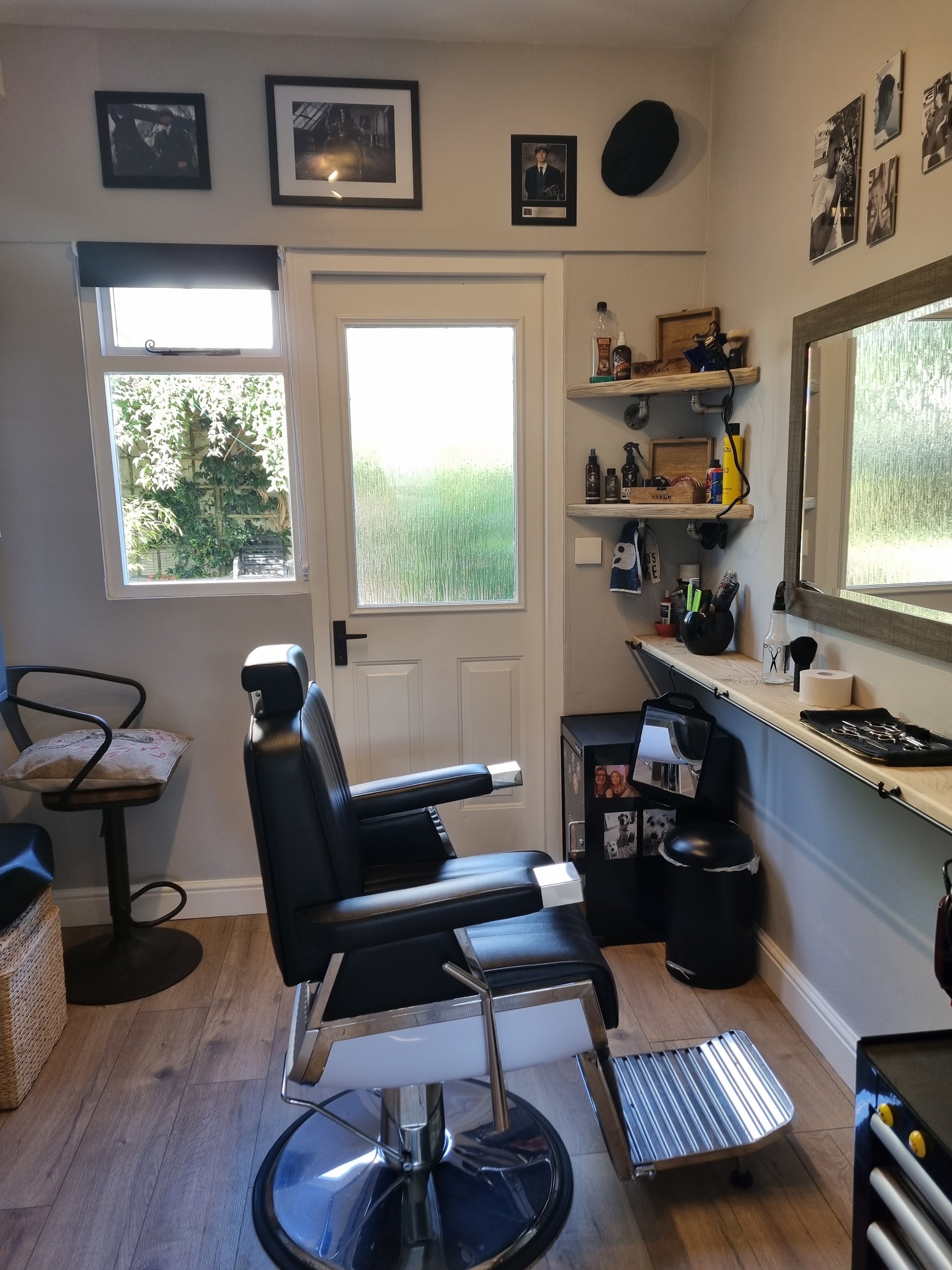 Black barber chair beside the back door and shelves of products