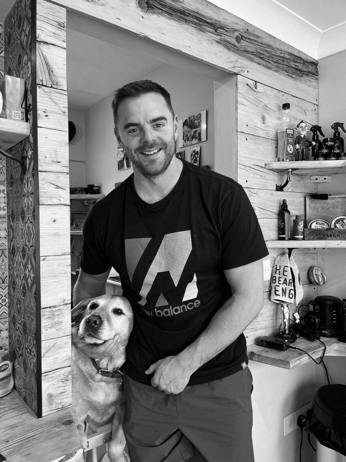 A smiling customer in a black T-shirt in the shop, black and white